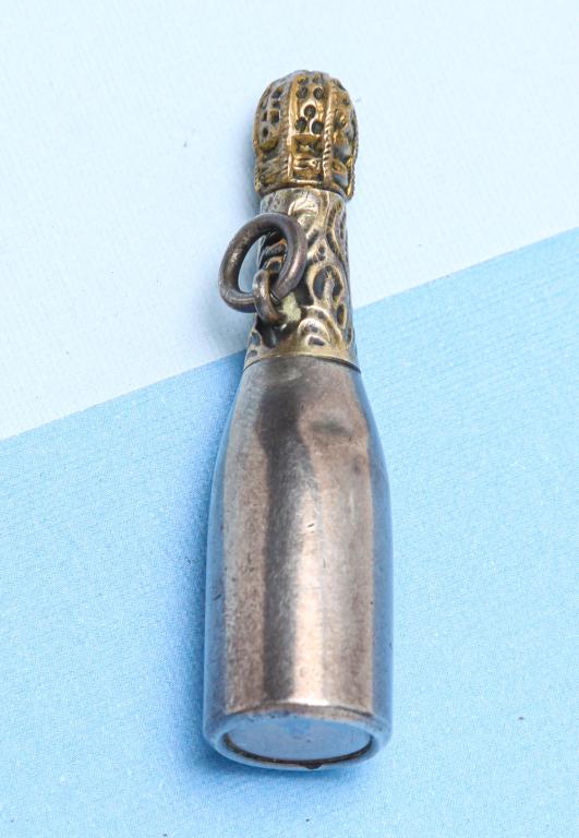 ANTIQUE CHAMPAGNE BOTTLE PROPELLING PENCIL.: American, late 19th century. Novelty silver propelling pencil designed as a champagne bottle, with gilded top to imitate the foil, finial set with a working compass,suspension ring. Stamped "FAIRCHILD