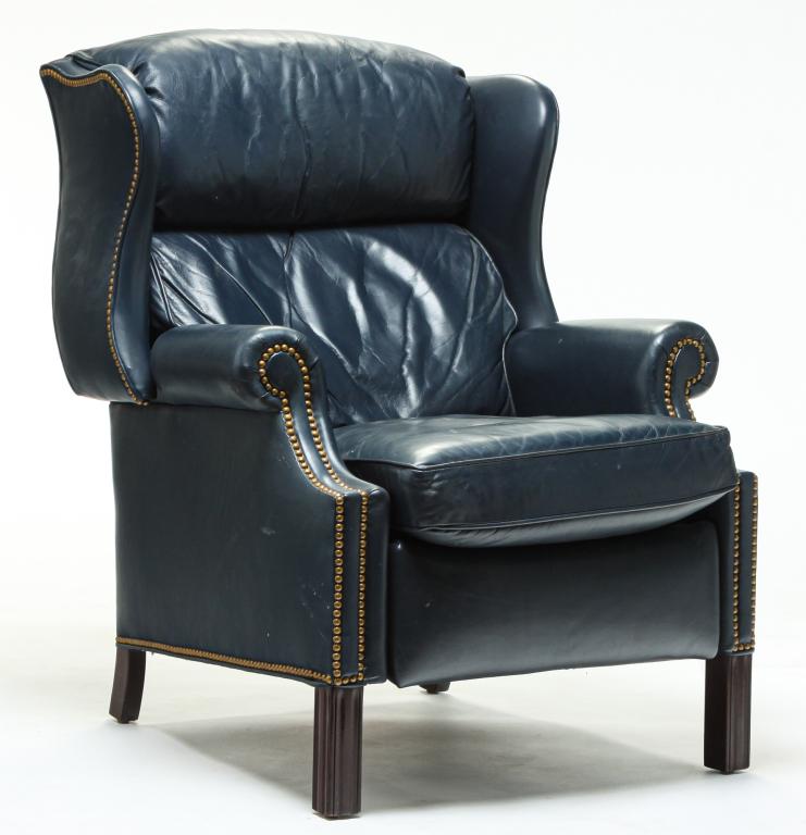 HANCOCK AND MOORE WING BACK CHAIR.: Late 20th century. Mahogany Chippendale style frame with blue leather upholstery, brass tack decoration. Reclines. Some minor wear. 20" seat, 41"h.