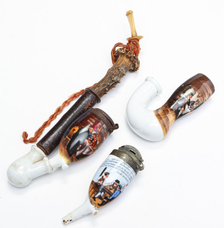 THREE GERMAN TRANSFERWARE PIPE BOWLS.: Early 20th century. Porcelain with hand painted transfer scenes of taverns. One with built in reservoir has hairline, 4"l., one marked "Tabak-Fabrik von PJ Landfried, Heidelberg" with white metal lid,