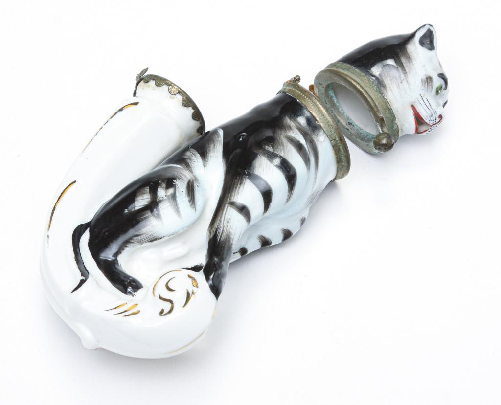 EUROPEAN FIGURAL CAT PIPE BOWL.: Late 19th century. Hand painted porcelain black and white tabby cat. Lid hinge is damaged, minor wear. 5.5"l.