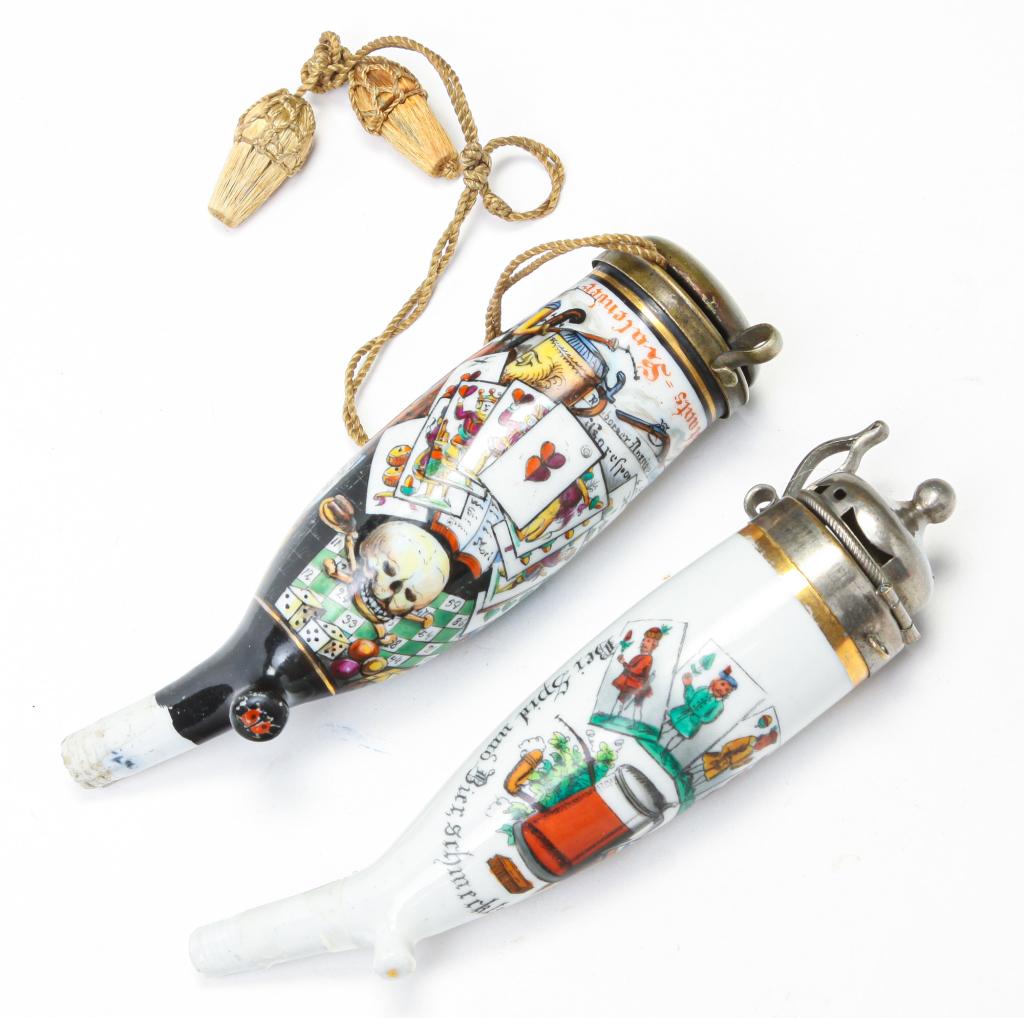 TWO GERMAN PORCELAIN PIPE BOWLS.: Early 20th century. Hand painted with various items centered around military, gambling, drinking, smoking and a momento mori skull. A few faint scratches, 5.5"l. And hand painted transfer with beer st