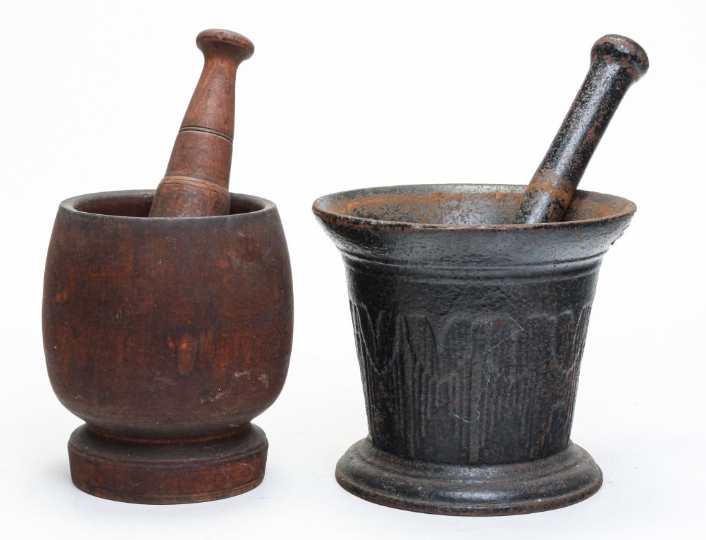 TWO MORTAR AND PESTLES.: Second half 19th century. One is treenware, 11.5"h. And larger is cast iron, 11.5"h.