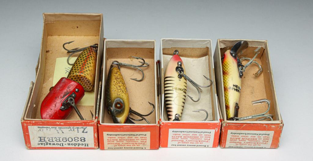 FOUR WOODEN HEDDON LURES IN ORIGINAL BOXES.: Four Heddon lures. American, mid-20th century. Includes two wooden River Runts with glass eyes, a wooden Laguna Runt, and a wooden Zig Wag with glass eyes. All are in original Heddon boxes.
