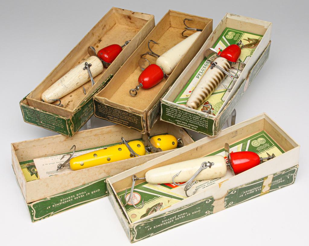 FIVE LARGE PFLUEGER FISHING LURES WITH BOXES.: Group of five Pflueger Famous Bait fishing lures. Includes three no. 3796, a no. 3750, and a no. 3704. All are 5.25" long and include the correct original boxes. Three have paper inserts in the boxes.