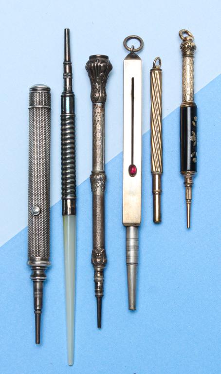 COLLECTION OF ANTIQUE PENCILS.: Mid-late 19th century. Six pencils to include: silver metal sheath vest pencil, retractable, red cabochon stone on slider; Mabie Todd & Co. sterling silver mounted mother-of-pearl pencil; silver prope