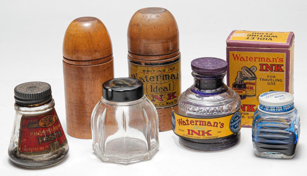 SMALL GROUP VINTAGE INK BOTTLES & WOODEN CASE.: First half - 20th century. Six pieces to incude: two Waterman's Ideal Ink wooden travel cases, label on one case has some wear. Label on other case missing, label on bottom in tact, with spring inside