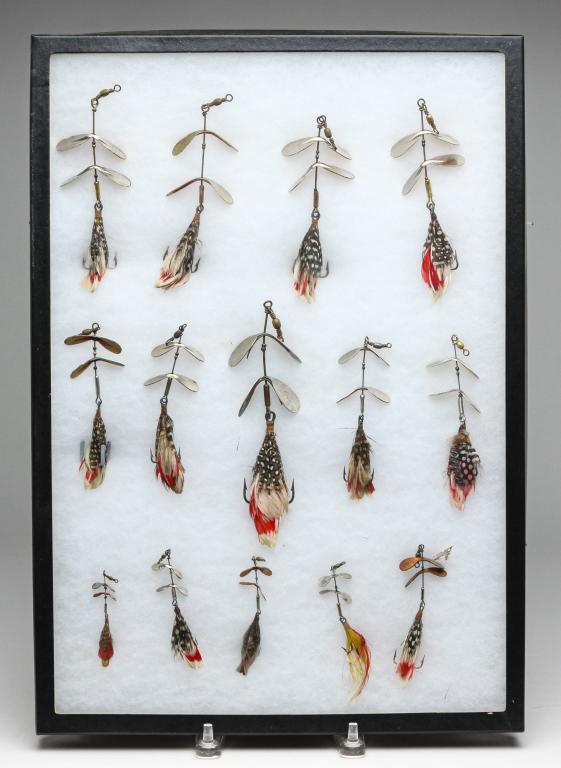 FOURTEEN PFLUEGER TANDEM SPINNER FISHING LURES.: Group of fourteen Pflueger Tandem Spinner fishing lures. Various sizes displayed in a glass top case.