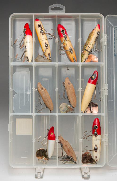 GROUP OF TEN HEDDON FLAP-TAIL FISHING LURES.: Group of ten Heddon Flap-Tail fishing lures. Two have glass eyes. Included is a Shimano clear tackle box.