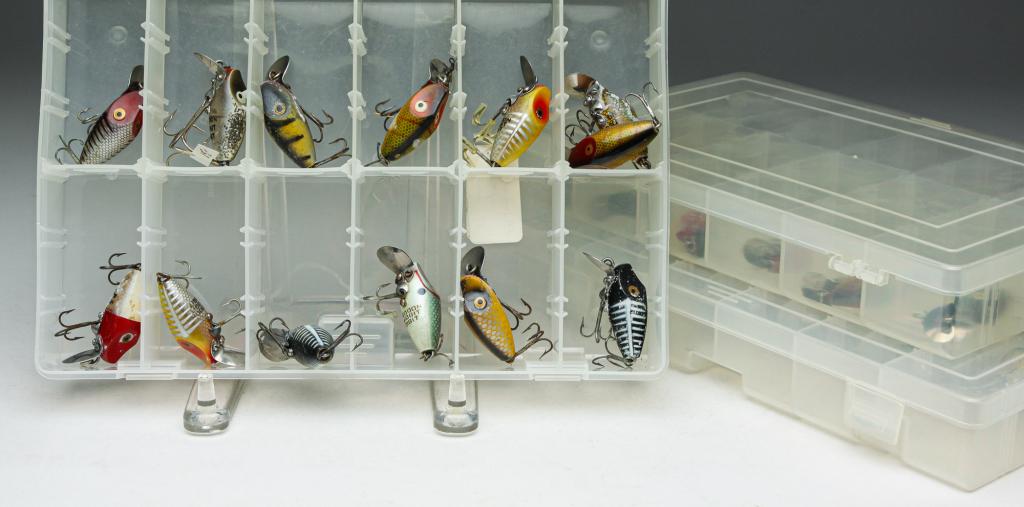 THIRTY-NINE HEDDON LURES INCLUDING TINY RUNTS.: Group of thirty-nine Heddon fishing lures. Includes twelve Tiny Runt lures and twenty-seven Midgit Digit lures. Included are three clear plastic tackle boxes.