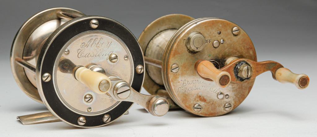 TWO AMERICAN FISHING REELS.: Mid 20th century. "Abbey Casting" with bakelite (?) or hard rubber panels. And "Brooklure Precision Bilt" (sic). Worn.
