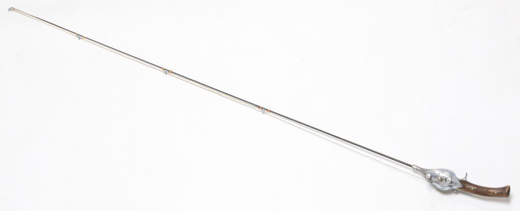 HURD SUPER CASTER FISHING ROD AND REEL.: Mid-20th century. Steel rod with integrated reel and wooden checkered pistol grip handle. Serial number 349411. 60" overall length.