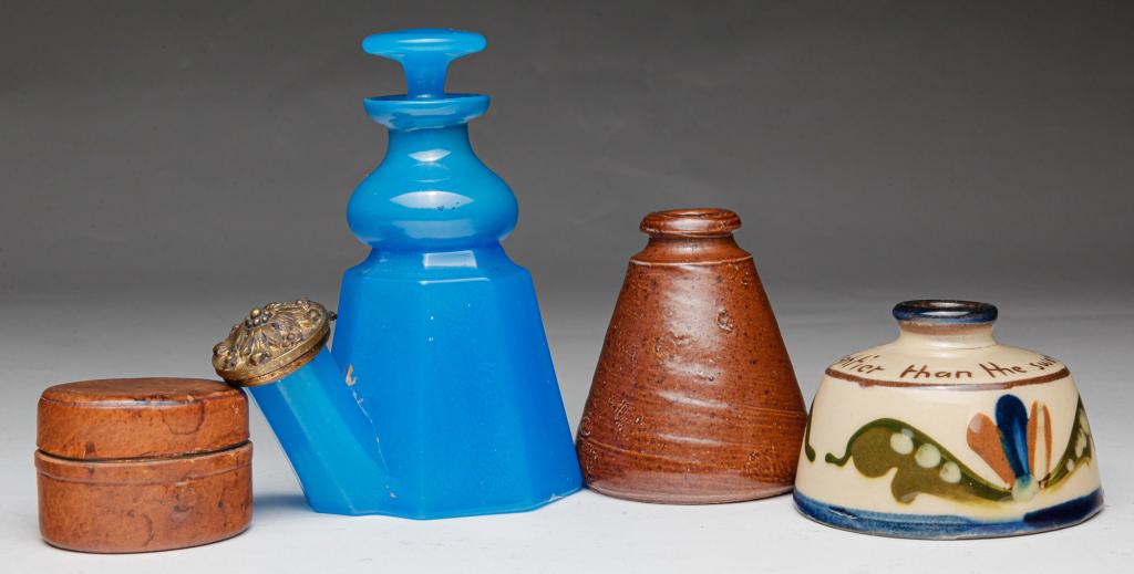 FOUR INKWELLS.: American and European, 19th-20th century. Stoneware, 2.5"h., cornflower blue glass with traces of gilding. Repaired lip, 4.25"h., sgraffito redware with illegible signature, 1.75"h. and traveling bras