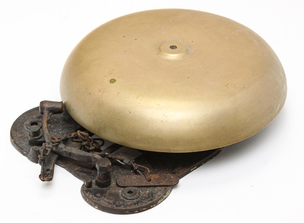 AMERICAN FIRE GONG.: Ca. 1900. Brass and cast iron. Dish-shaped gong on wall bracket with spring action. 16"h. 12"w.