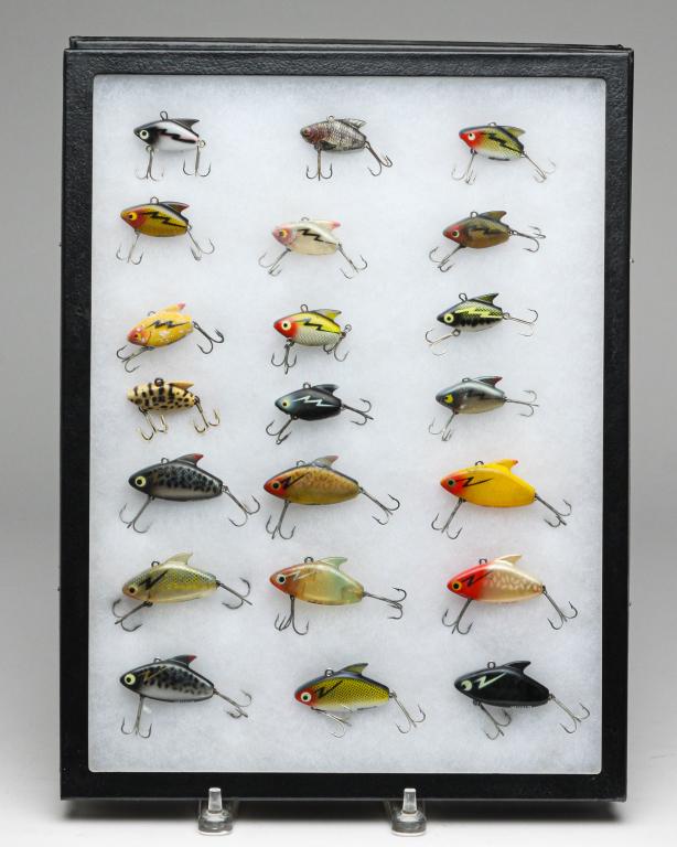 TWENTY-ONE HEDDON SONIC AND SUPER SONIC LURES.: Group of twenty-one Heddon fishing lures. Includes twelve Sonic lures and nine Super Sonic lures. All are displayed in a glass top display case.