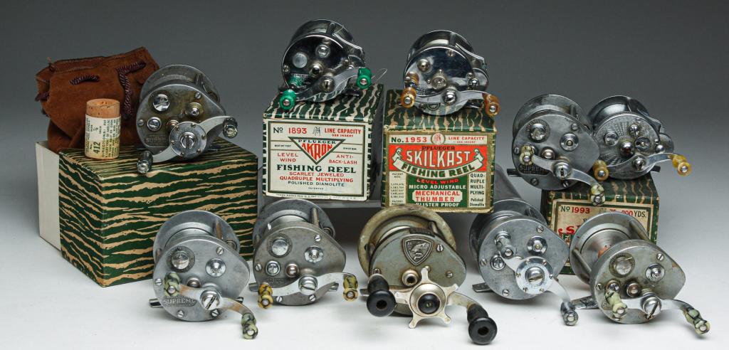 TEN PFLEUGER BAIT CASTER REELS.: Mid 20th century. Seven "Supreme", one has original box. leather bag (damage), spare parts and booklet. Together with three having original boxes. "Skilkast" (bag and booklet), "Summit" (booklet) and