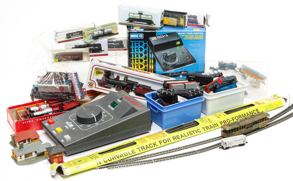 GROUP OF MOSTLY N GAUGE RAILROAD TOYS.: Late 20th century. Diesel and steam locomotives, freight, passenger, tank and other cars, track, switches, buildings, transformers and etc. Also including several HO gauge locomotives and a brass stre