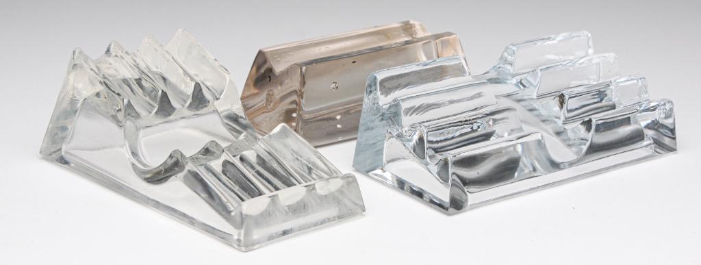 THREE VINTAGE GLASS PEN HOLDERS.: 20th century. Three clear glass pieces to include: antique paperweight/pen holder embossed 'James Adair, Sewickley, PA, Patented January 30-1900'; one with three horizontal slots; Together with one to