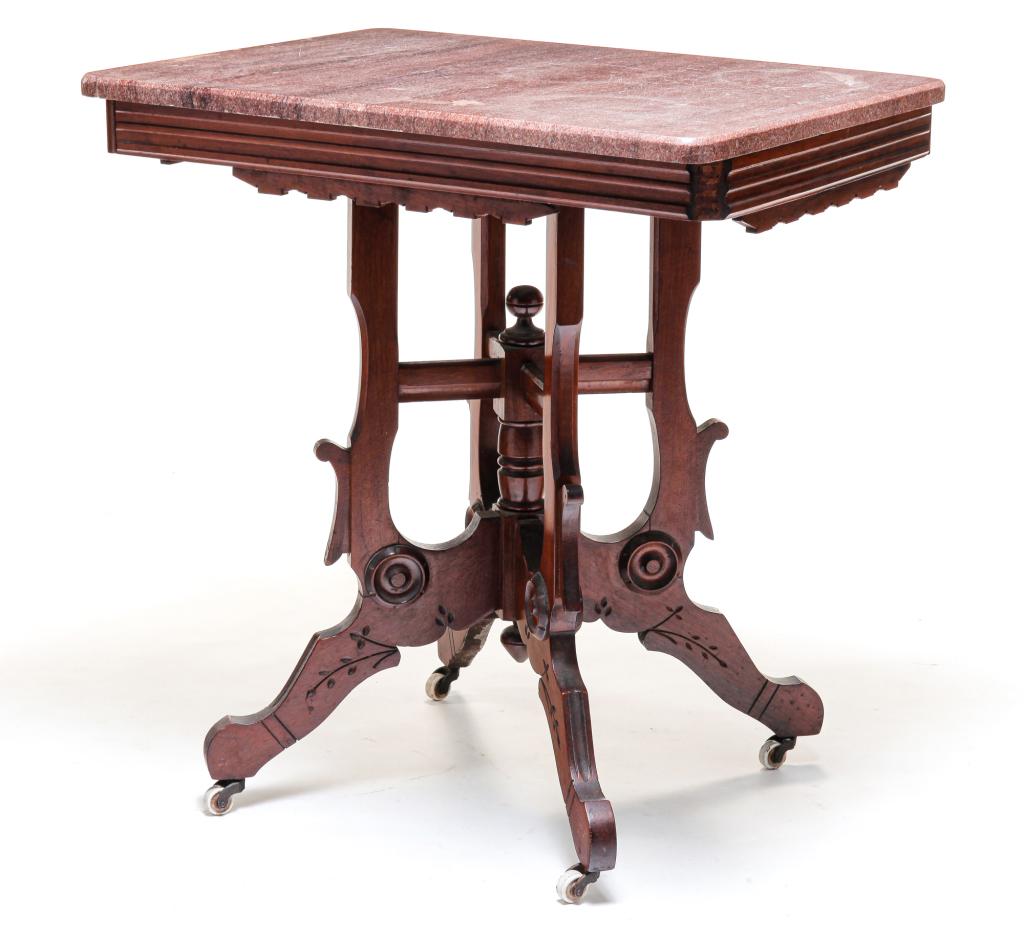 AMERICAN EASTLAKE PARLOR TABLE.: Fourth quarter 19th century, walnut. Pink marble top and base with turned center column and legs with typical Eastlake decoration. 29.5"h. 28"w. 20"d.