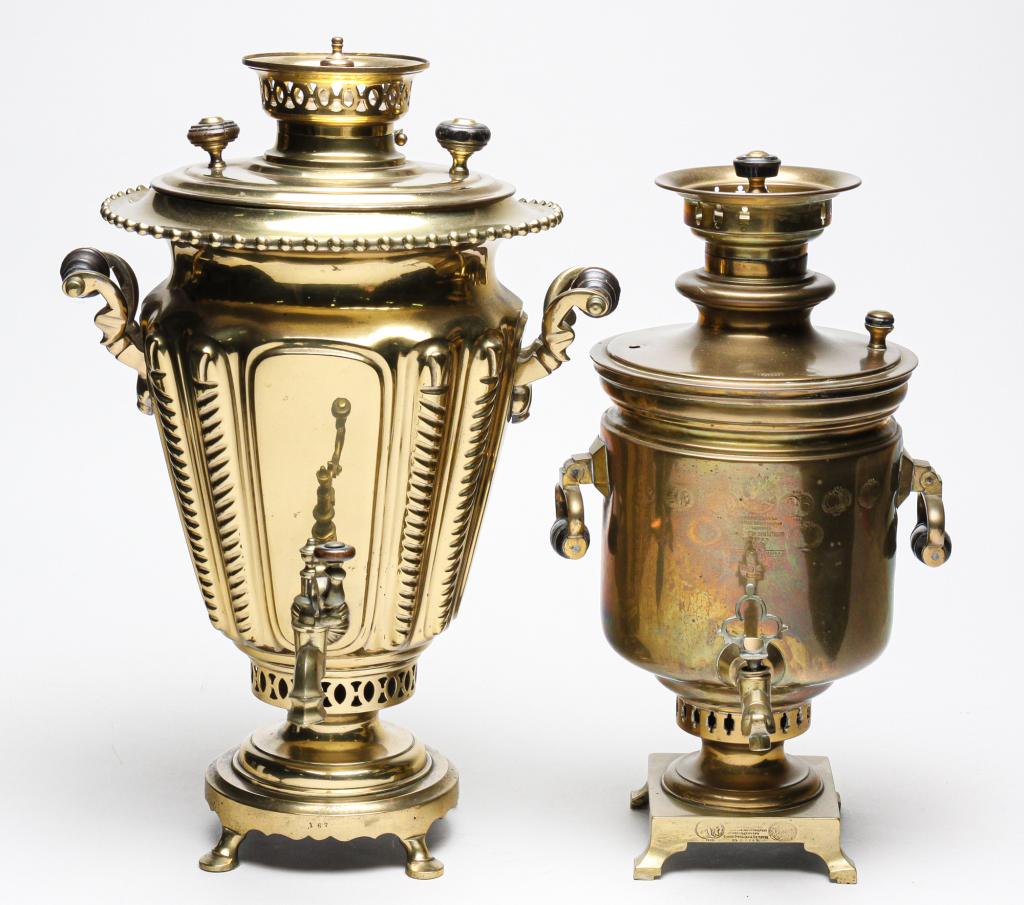 TWO RUSSIAN SAMOVARS.: Second half 19th century, brass. One is typical shape with inspection stamps from 1870 to 1893. Missing one lid handle, 19.5"h. Other has stamped makers name on lid, squarish shape with canted sides a