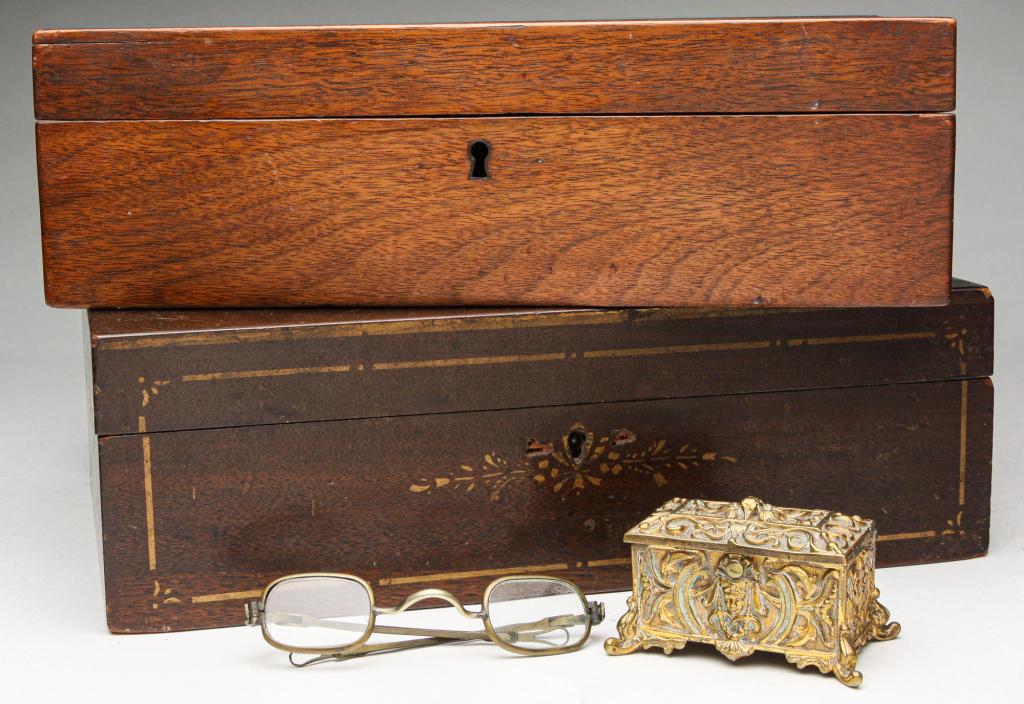 THREE AMERICAN BOXES AND PAIR OF GLASSES.: Late 19th century. Two mahogany document boxes: one with gold stenciling and wallpaper interior, 4.25"h. 11.75"w. 8.25"d. And plain, 3.5"h. 11.25"w. 7.75"d. Heavy cast brass box, 1.75"h. And eye glass