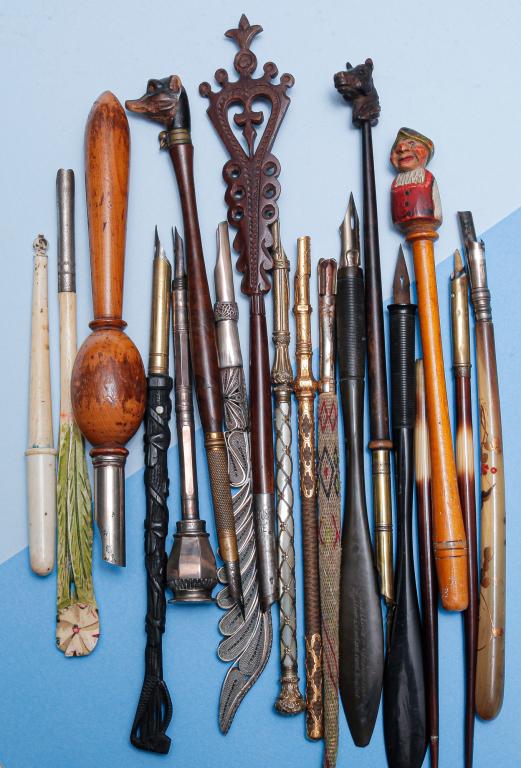 UNUSUAL GROUP OF VINTAGE DIP PENS.: Mid 19th - early 20th century. Collection of eighteen dip pens in a variety of materials, some novelty pieces. Group includes: two carved wood pens - one terminal with a carved horse's head, one with 