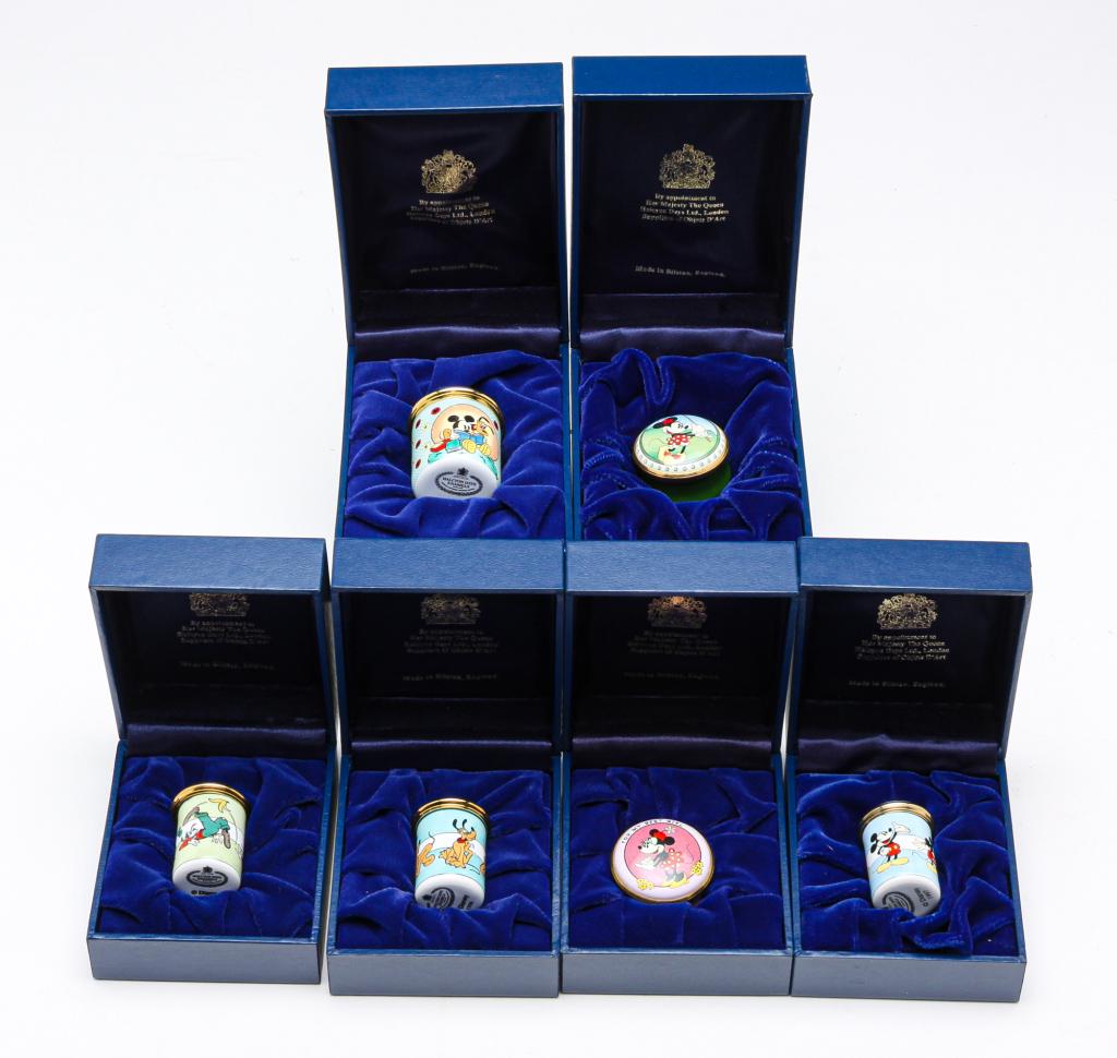 SIX HALCYON ENAMEL DISNEY BOXES.: Late 20th century. Four cylinder-shaped, "Goofie" 1996, "Pluto," 1996, "Mickey," 1997, 1.25"h. And "Friends Forever" Mickey and Pluto, 1996. 1.5"h. And two with Minnie Mouse, "Golfing" and "For my Bes