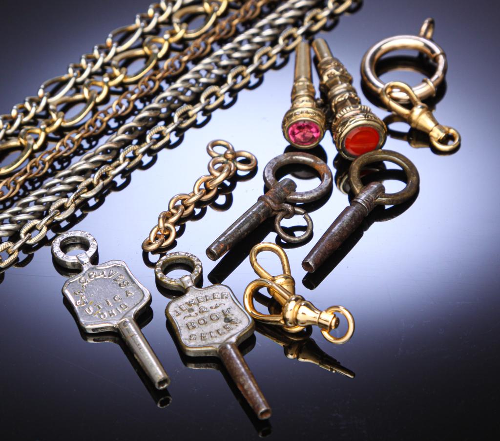GROUP OF WATCH KEYS, CHAINS, AND FINDINGS.: Nineteenth and 20th centuries. Two keys are advertising: EDE Koh, Sidney, OH and CA Graves, Utica, OH. And two keys have cut stones or glass. PLEASE NOTE: watches are not guaranteed to be in working c