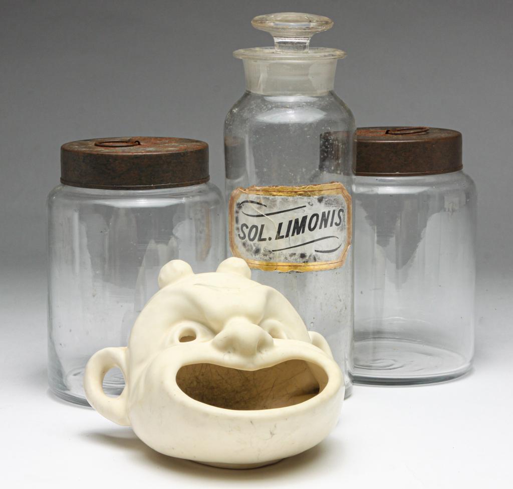 TWO GLASS CANISTERS, JAR AND ROOKWOOD ASHTRAY.: Twentieth century. Pair of late Asian blown glass canisters with tin lids, 5.5"h. 4"d. and an early American blown glass apothecary jar with reverse glass label "Sol. Limonis". Damage. 8.5"h. Together