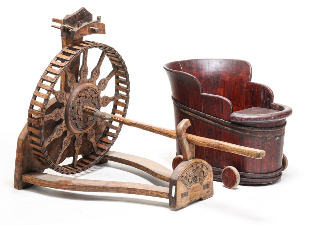 CHINESE SPINNING WHEEL AND BABY BUGGY.: Twentieth century. Elm spinning wheel on base with relief carved and stained floral decoration. Mostly complete with some edge loss. Base 38"h. 31"w. 23"d. And a stave constructed baby buggy with red
