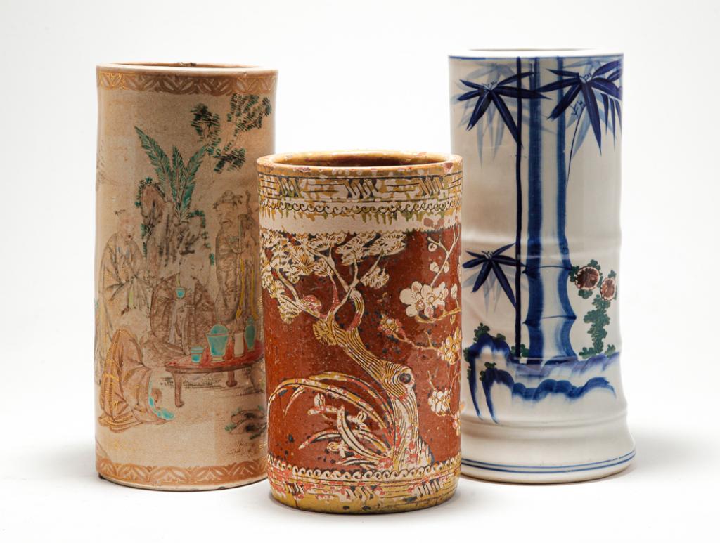 THREE CHINESE BRUSH POTS.: Late 19th-early 20th century. Redware with flowering trees. Glaze loss, 9.25"h. and ivory ground with figures similar to Satsuma. Worn decoration, hairlines, stains. 11.5"h. And porcelain with cobalt