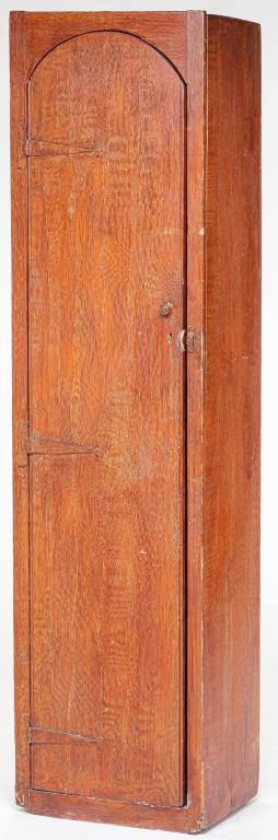 AMERICAN GRAIN-PAINTED GUN CABINET.: Mid 19th century, pine. Door with rounded top, beaded edges and strap hinges. Fitted interior with room for four rifles and shelf for accoutrements. Some wear and abrasions. 62"h. 16.5"w. 10"d.