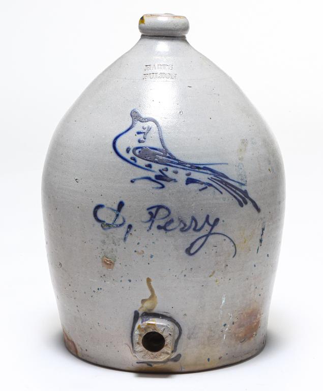 AMERICAN HART'S STONEWARE JUG WITH BUNG HOLE.: Second half 19th century. Impressed "Hart's, Fulton" with cobalt freehand bird and D. Perry. Burst bubbles, firing cracks and cracks. 17"h.