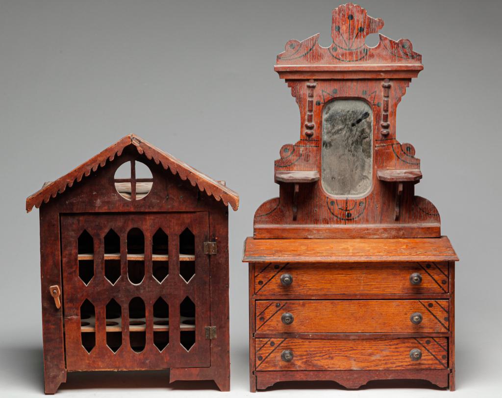 HANGING CABINET AND MINIATURE DRESSER.: Late 19th century. European, building-shaped, hanging cabinet with peaked cornice with scrolled trim, round window and open-work door. Damage and wear. 16.5"h. 13"w. 6.5"d. And an ash, miniature, East
