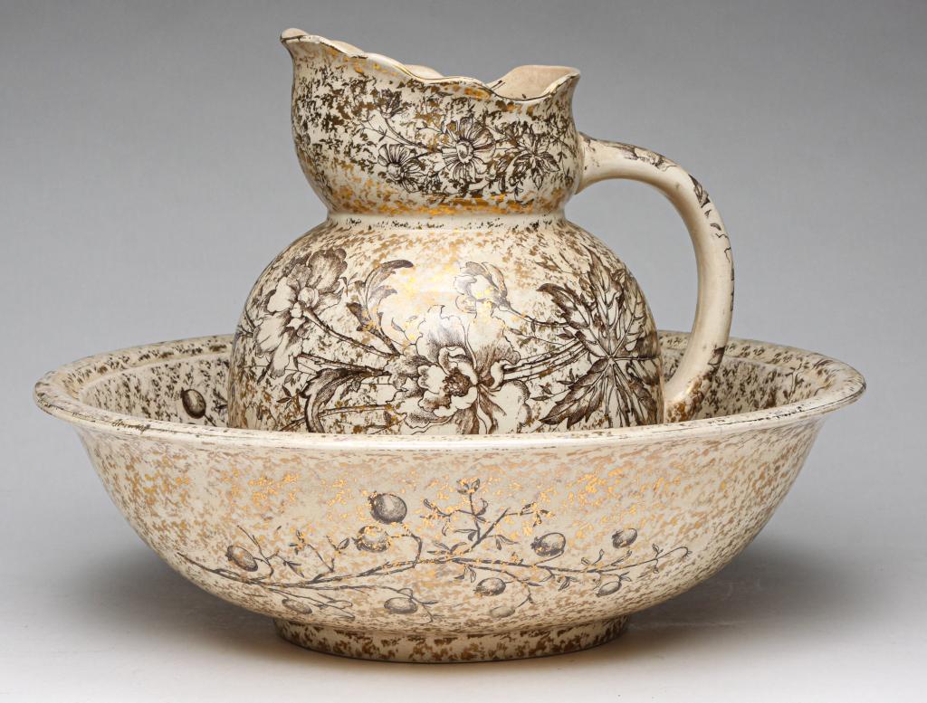 ENGLISH "DOULTON BURSLEM" WASH BOWL AND PITCHER.: Fourth quarter 19th century. Brown floral transfer with gold overall. Staining. 11"h. 15.5"d. overall.