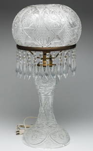 EUROPEAN CUT GLASS TABLE LAMP.: Twentieth century. Mushroom shape with "Hob Star" variant pattern. Brass fittings and missing one strand of three prisms. 26"h.