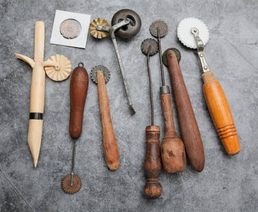 EIGHT PIE CRIMPERS.: American and German, nineteenth century. Including one whale bone, one blacksmith made, six one cent crimpers and one German ceramic crimper. Includes one extra large cent crimper. Varying wear,