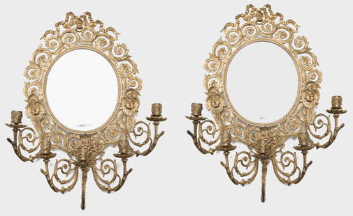 PAIR OF EUROPEAN MIRROED WALL SCONCES.: Ca. 1900. Brass frames with scrolled foliage, branches and beveled mirrors. 24"h. 17"w.