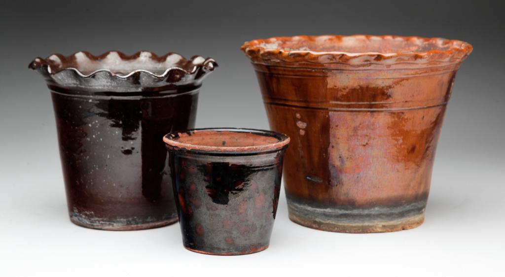 THREE GLAZED REDWARE FLOWER POTS. (1 of 4)