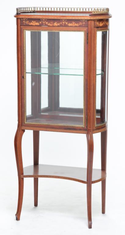EUROPEAN INLAID CURIO CABINET.: Ca. 1900, mahogany. Brass gallery, floral, marquetry and line inlays, curved glass side panels, brass liners around glass, curved legs and lower shelf. Refinished. 56"h. 26"w. 14.5"d.