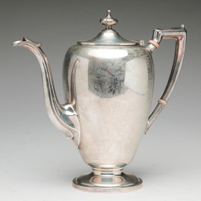 AMERICAN REED AND BARTON STERLING COFFEE POT.: Mid 20th century. Very simple footed shape with bone wafers on handle. 9.5"h. Approx. 80 ozt.