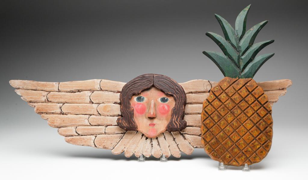 TWO FOLKSY CARVED PLAQUES. (1 of 4)