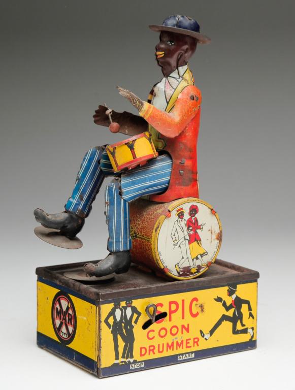 MARX TIN WIND UP DRUMMER TOY.: First quarter 20th century. "Spic Coon Drummer" lithograph on tin, patented December 1924. Some wear and missing one drumstick. Sluggish, but works. 8.75"h.