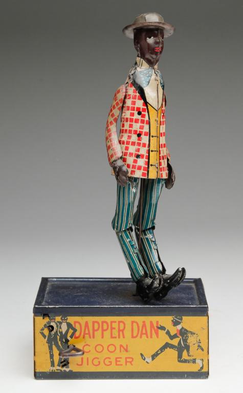MARX "DAPPER DAN" TIN TOY.: Patented May 24, 1910. "Dapper Dan, Coon Jigger" lithograph on tin, some wear. Works well. 10"h.