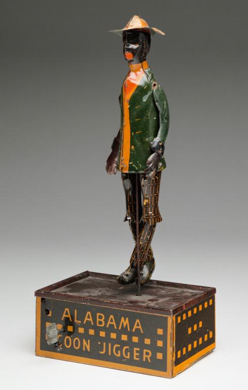 STRAUSS WIND UP DANCING TIN TOY.: Patented May 24, 1910. "Tombo the Alabama Coon Jigger" lithograph on tin, some wear. Works well. 10.25"h.