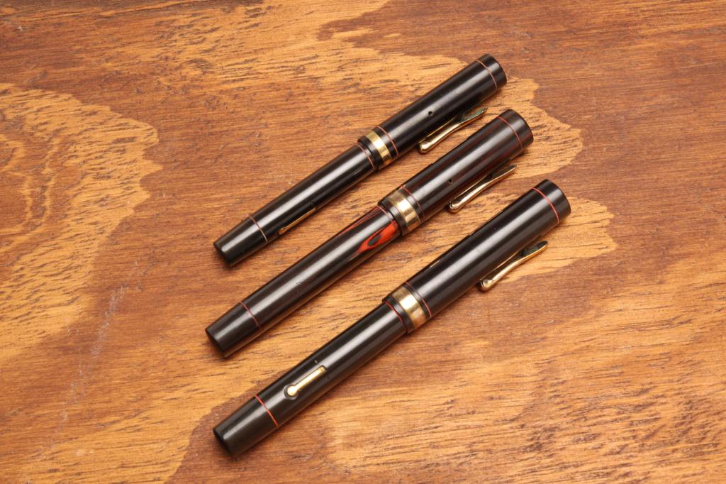 THREE WOOD GRAIN CONKLIN FOUNTAIN PENS. (1 of 3)