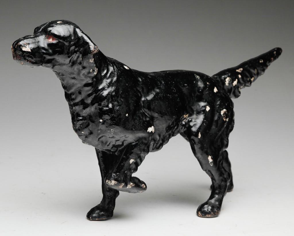AMERICAN CAST IRON DOORSTOP.: First quarter 20th century. A hunting dog with worn, layered paint. 9"h.