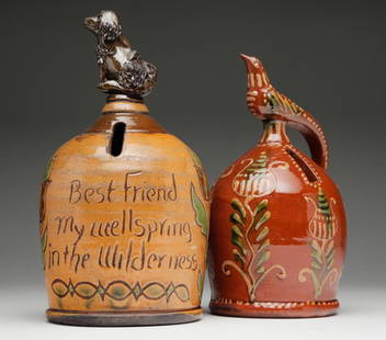 TWO CHRIS WOODS REDWARE FIGURAL BANKS.: Twenty First century, American. Both signed and dated. One bank with a bird atop and floral decoration. 8"h. One Bank inscribed "Best friend my wellspring in the wilderness" with a dog atop. 9"h.