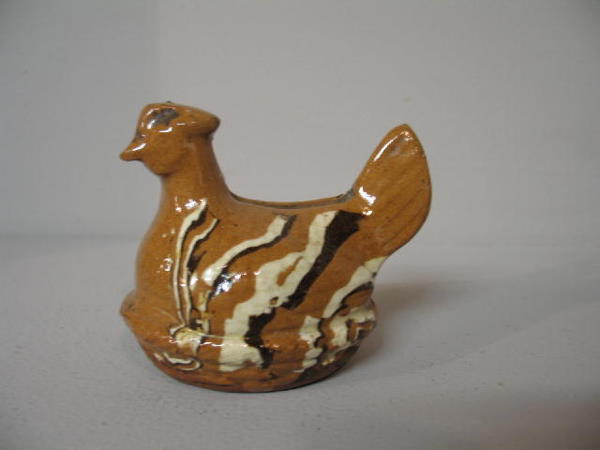 REDWARE HEN ON NEST BANK. White and dark brown ver: REDWARE HEN ON NEST BANK. White and dark brown vertical striped glaze. 3 1/4"h.