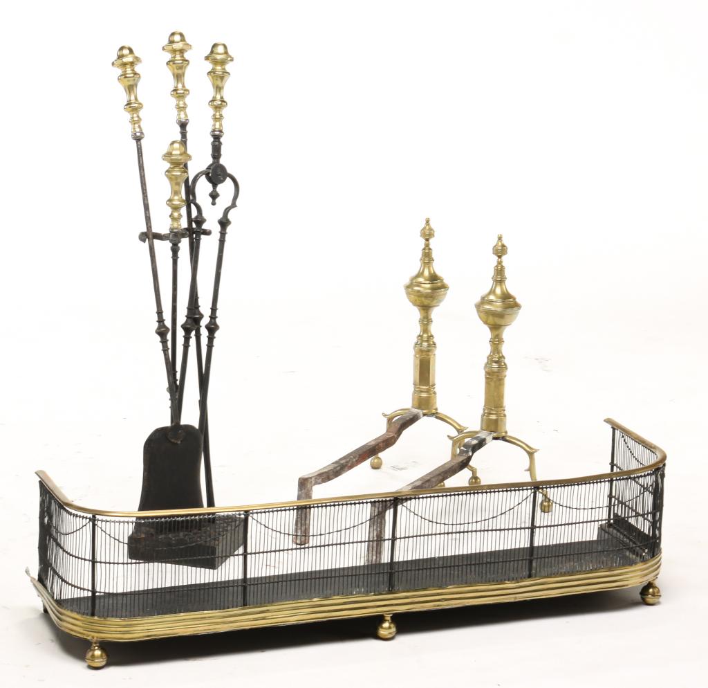 AMERICAN BRASS FIREPLACE SET.: Nineteenth century. Pair of seamed andirons, 21"h. and set of brass and iron tools in stand. One handle has small hole. 36"h. with tools. Together with a brass and wire fireplace fender. 10"h. 42"l.