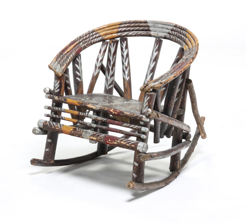 AMERICAN ADIRONDACK CHILD'S ROCKER.: First quarter 20th century. Plank seat with branch and bentwood elements. Elaborate original paint including gold and silver. Traces of a paper label or sign on the underside, some edge loss. 18"h. 17